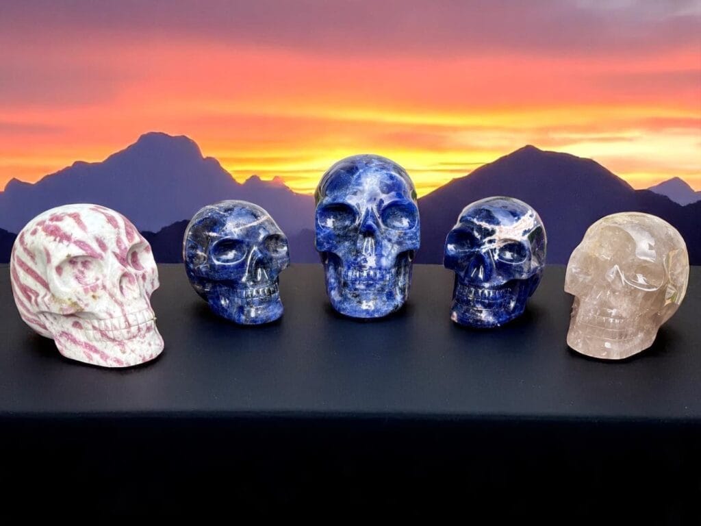 Featured image of hand-carved crystal skulls from Brazil against a mountain sunset